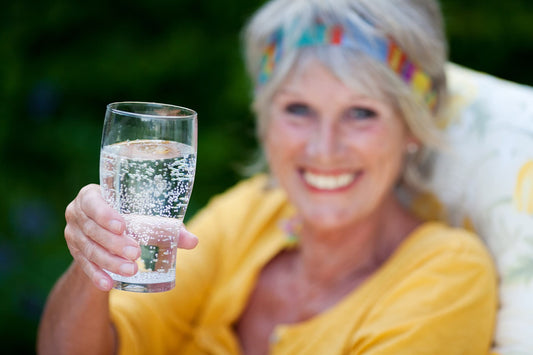 lady drinking a glass of sparkling water